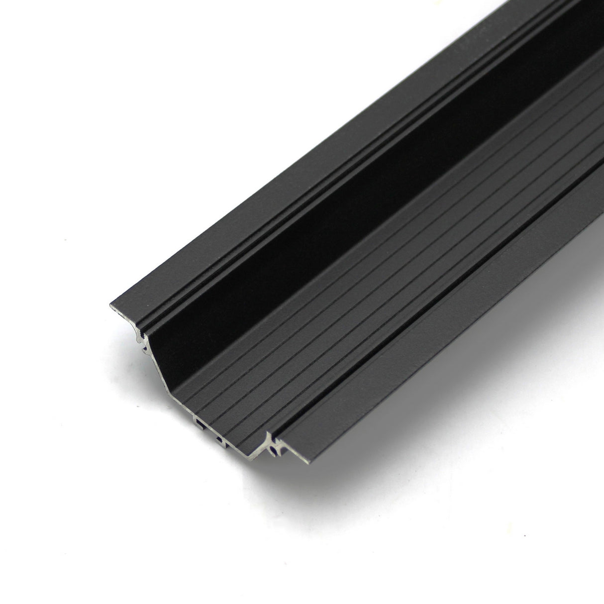 A close-up of the Shallow Ceiling Recessed LED Lighting Channel, Model Amara, in black aluminum with a grooved, textured surface, shown on a white background.
