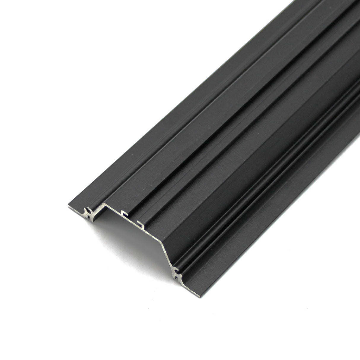 A close-up of the Shallow Ceiling Recessed LED Lighting Channel ~ Model Amara, featuring black extruded aluminum with multiple grooves and a flat surface, ideal for framing or recessed lighting in construction projects.