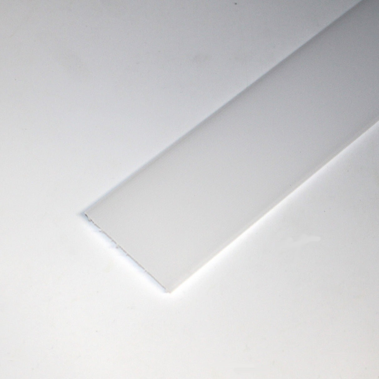 The LED Diffuser for Easy-On Architectural Profiles is a flat, rectangular white plastic strip with one smooth and one slightly uneven edge, shown on a plain white background.