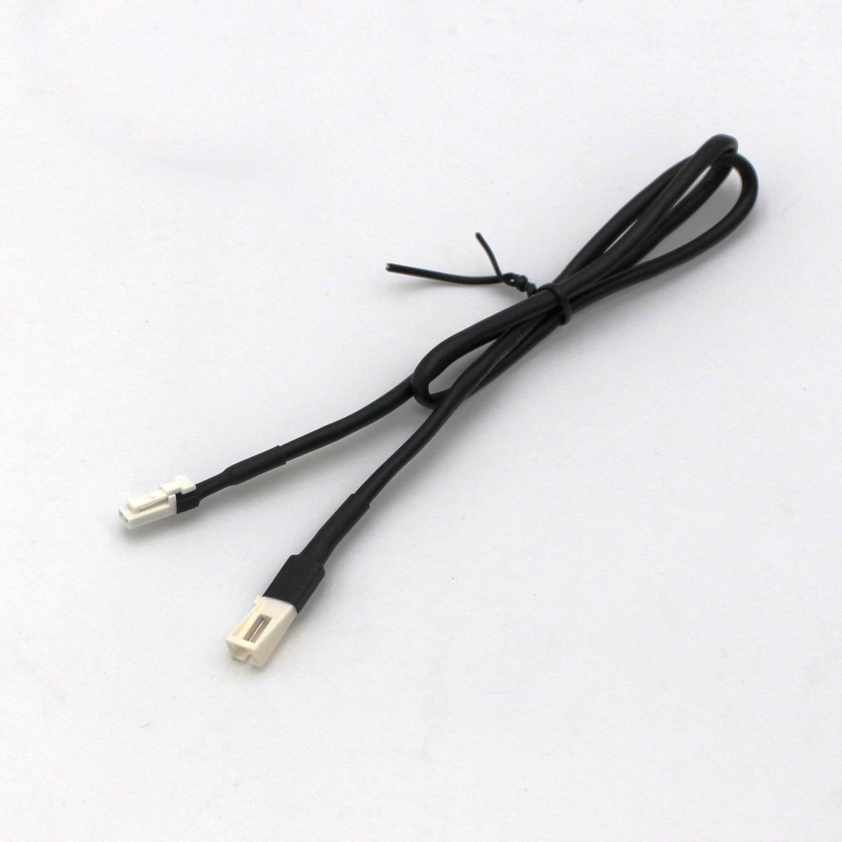 A coiled Micro-Plug Extension Cable - Male to Female, featuring black micro connectors, is neatly secured with a small black twist tie and placed on a plain white surface.