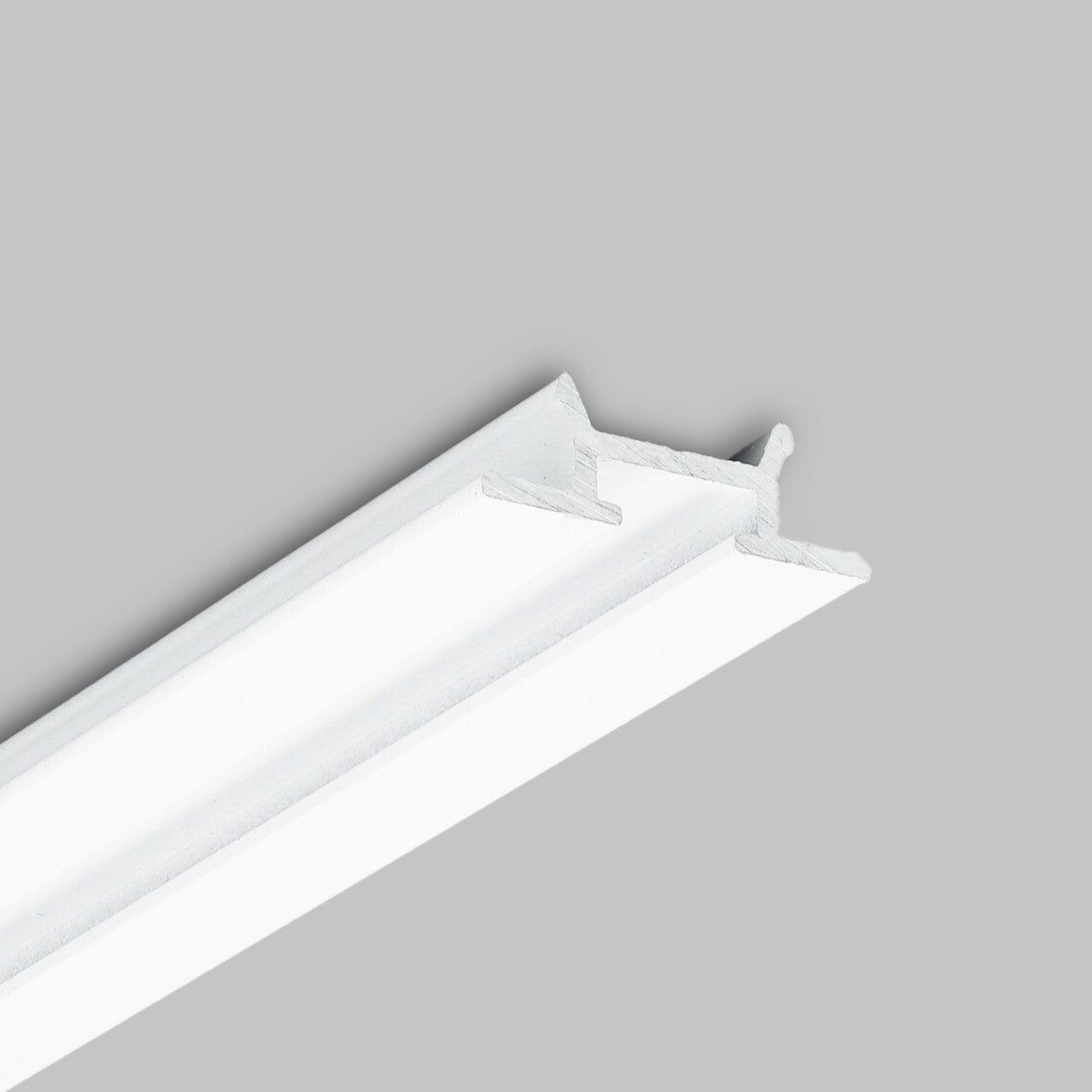 A white, T-shaped ceiling tile grid (Complementary Profile ~ Model Pixy20-03) is shown against a plain grey background, viewed at an angle. This design features an aluminum profile that pairs seamlessly with architectural lighting fixtures such as the Pixy20 LED profile.