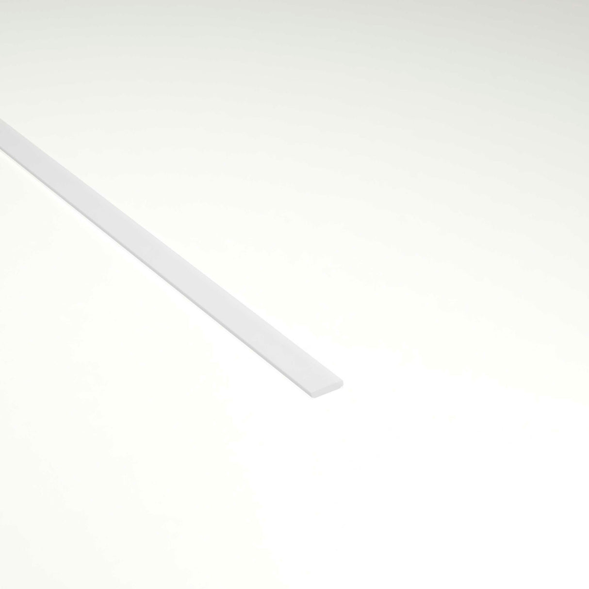 A long, thin LED Diffuser for Amsterdam Mini Profile lies diagonally on a plain, light background, with most of the strip positioned in the upper left portion of the image.