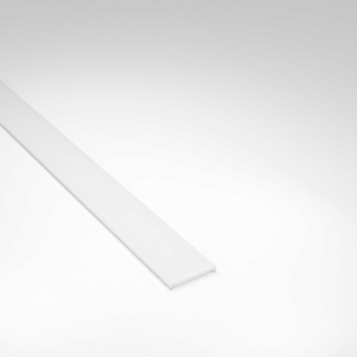 A long, narrow LED Channel Cover for Badalona Profile with a flat surface is placed diagonally on a plain, light gray background.
