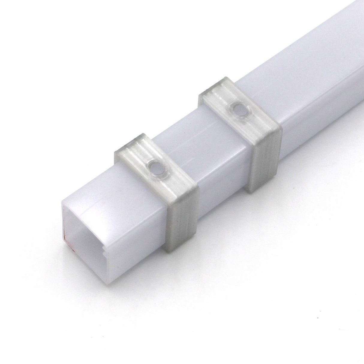 A set of two transparent 3D printed Mounting Clips for Visby Profile, ideal for securely attaching Visby diffuser or LED diffuser tubes to a white rectangular plastic cable trunking.