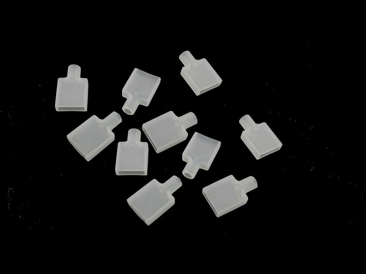 Ten Waterproof End Cap Covers for IP67/IP68 LED Strips, made of translucent plastic with a flat base and short cylindrical necks, are randomly arranged on a black background—ideal for protecting LED strip ends.