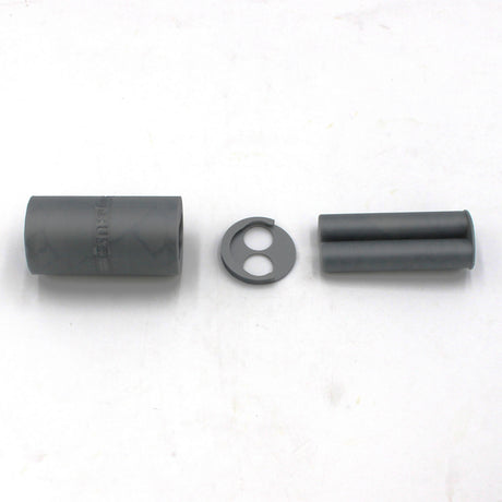 Three gray cylindrical components and one round disc with two holes, all likely parts of the 3D-Printed Caulking Gun Adaptor for Methacrylate 50ml 1:1 Mix, are arranged in a row on a white background.