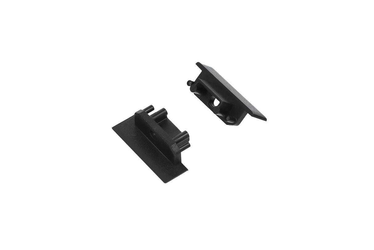 Two small black plastic end caps with rectangular bases and protruding clips, designed for secure attachment to the Groove10.v2 Profile lighting fixture. They are displayed on a white background.