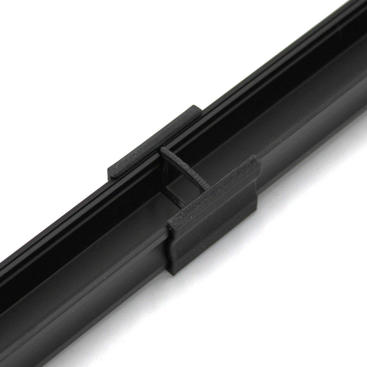 Close-up of a black Linear Connector for SL15 Profile with a PETG center piece, shown against a white background.
