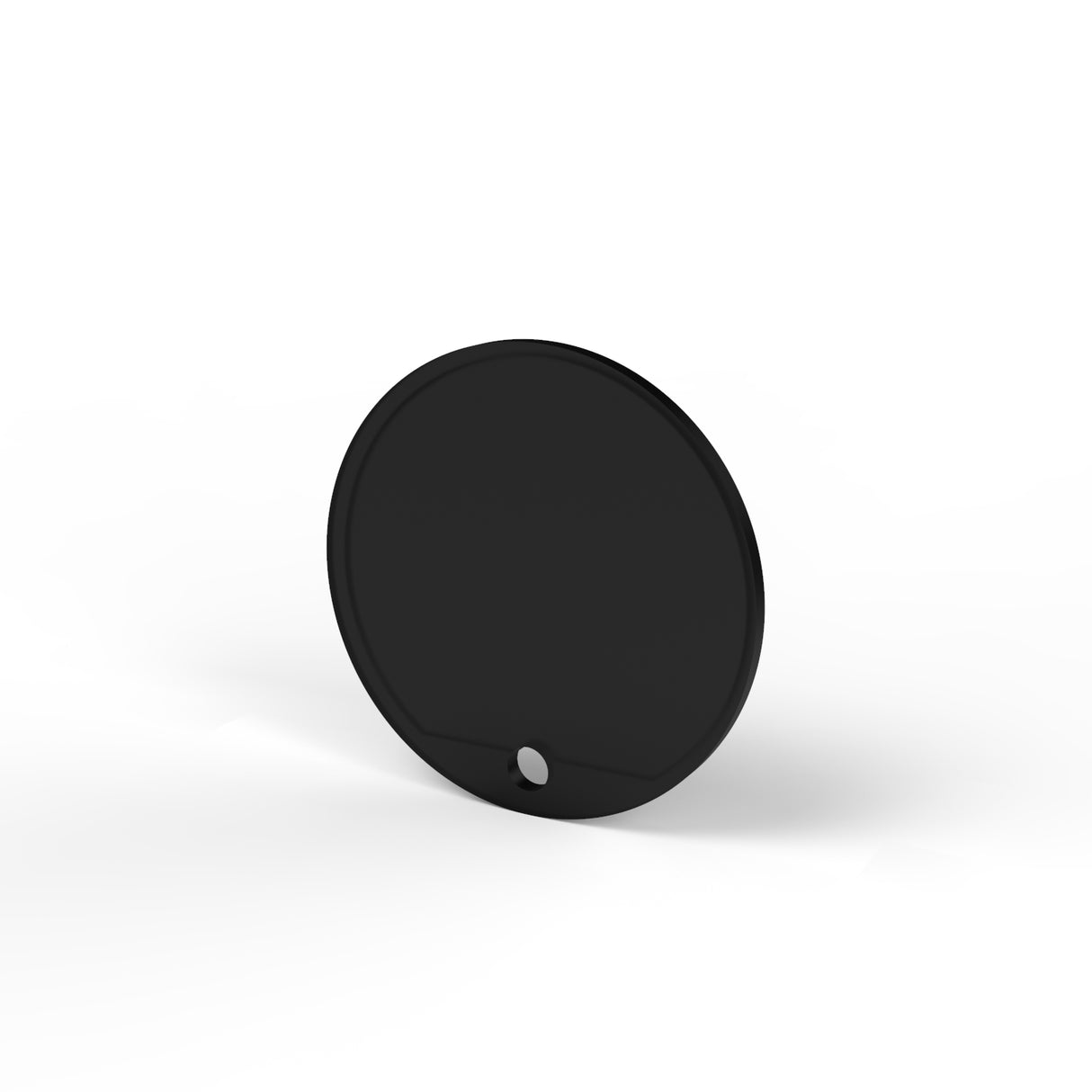A black, flat, circular Plastic End Cap for Sierra65 Profile stands upright on a white surface with a small hole near its bottom edge, showcasing its minimalist design.