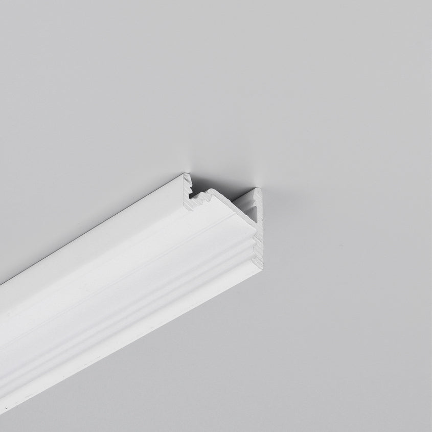 A white crown molding with a decorative edge is mounted where a light gray wall meets the ceiling, creating a clean transition between the two surfaces. The 30/60 Degree Corner LED Channel ~ Model Corner10.v2 can be seamlessly integrated along the molding, providing stylish and functional accent lighting.