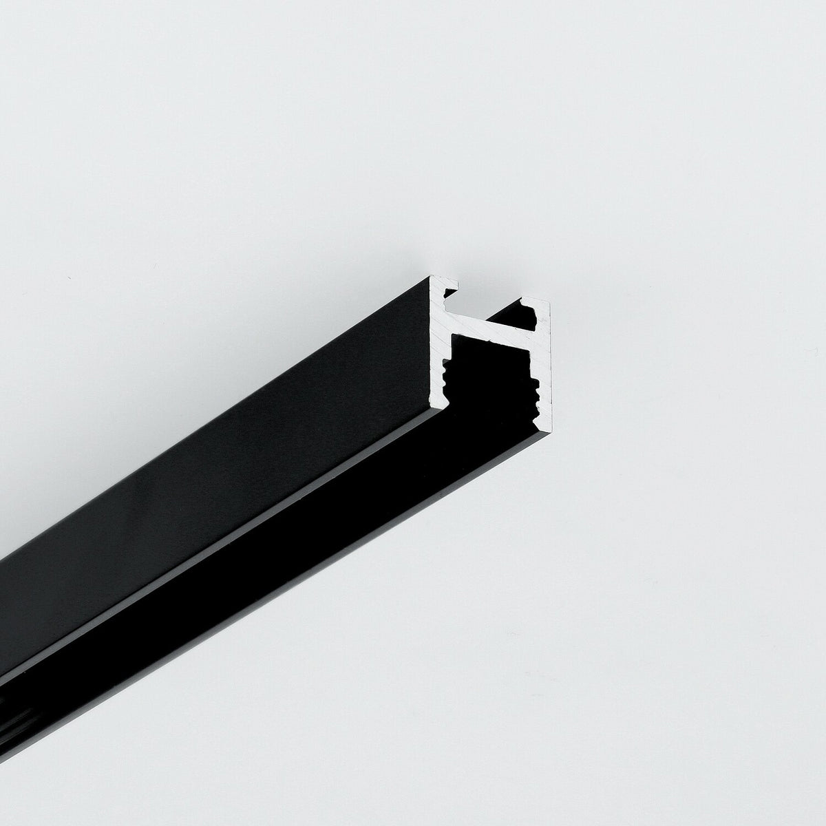 A black, U-shaped 0.51″ Suspended/Surface Mount Bendable LED Channel ~ Model Bend8 with an exposed silver-toned interior rail for curved lighting installations.
