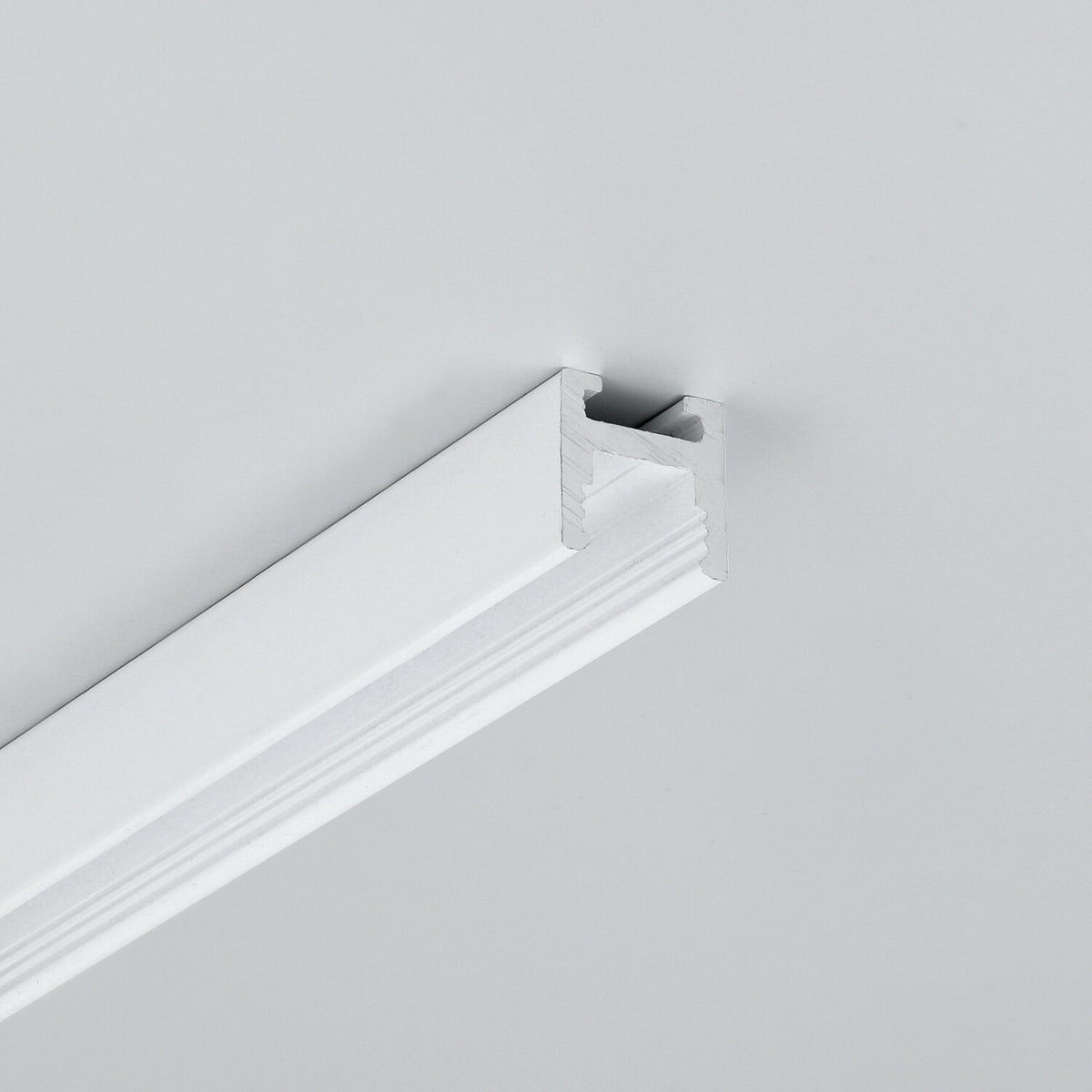 White metal 0.51″ Suspended/Surface Mount Bendable LED Channel ~ Model Bend8 mounted to a ceiling.