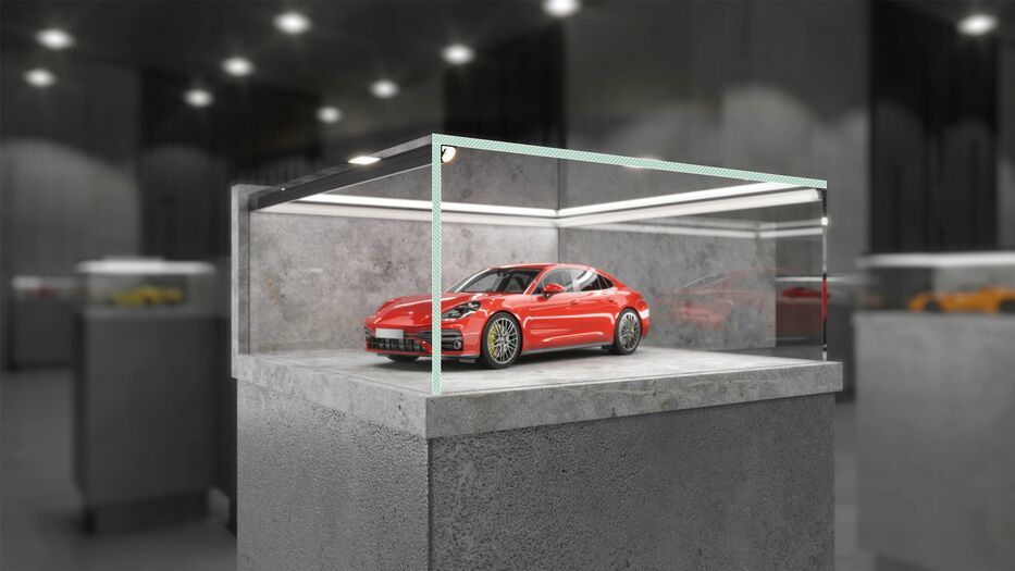 A red sports car model is showcased in a glass case atop a concrete pedestal, illuminated by Model Cabi12 30/60 Degree Corner LED Channel, in a sleek, dimly lit exhibition space with other display cases visible in the background.