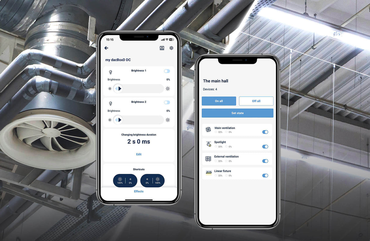 Two smartphones display smart building control apps for the Smart WiFi 2-Channel 0-10V Controller (Model dacBoxD DC), enabling remote lighting and ventilation management, set against industrial ceiling pipes and a large circular air vent.