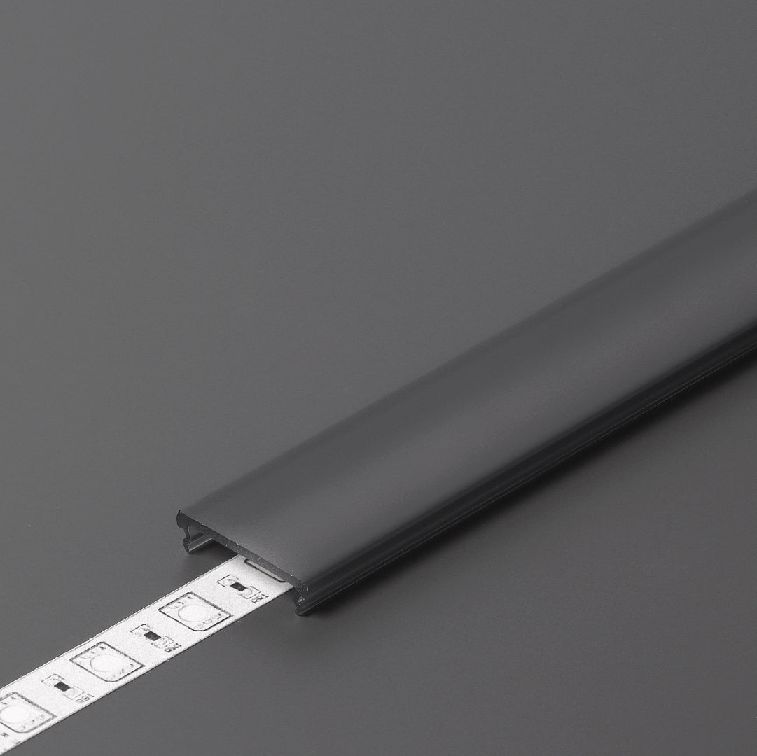 The LED Channel Cover ~ F Click in black partially covers a white LED strip light, displayed on a dark gray surface.