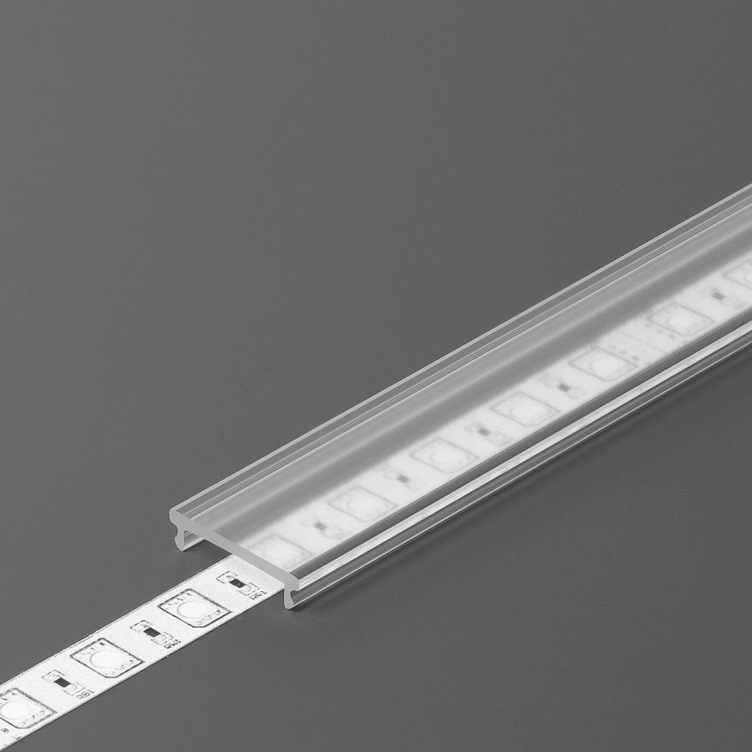 The LED Channel Cover ~ F Click, a transparent rectangular channel, securely houses a white LED strip on a gray surface, demonstrating its ability to neatly protect and organize lighting installations.