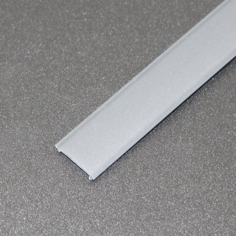 A close-up of the LED Diffuser for Standard Easy-On Profiles, a straight, flat, silver strip, lying on a textured gray surface.