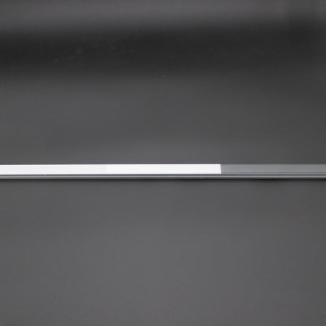 A slim, silver and white LED Diffuser for Standard Easy-On Profiles features a polycarbonate cover, placed horizontally on a smooth dark gray surface with a minimalistic background.