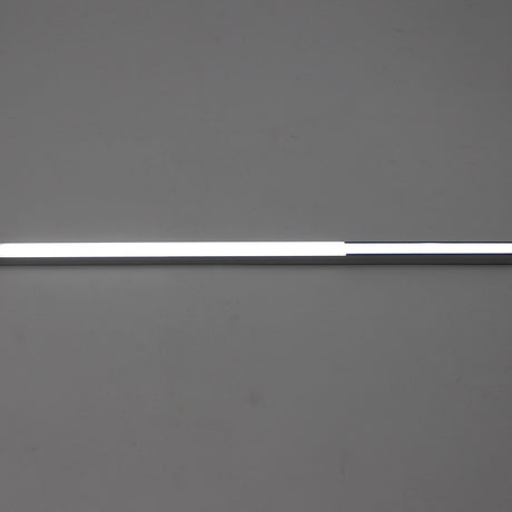 A LED Diffuser for Standard Easy-On Profiles, slim and long with a polycarbonate cover, is mounted horizontally on a plain gray wall; its left side glows while the right side remains unlit.