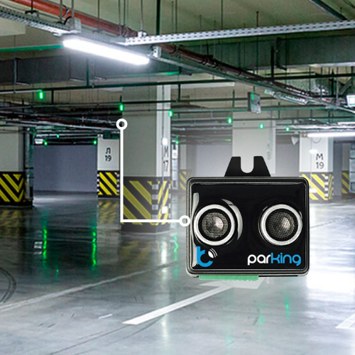 A modern underground parking garage features green lights above spaces and a close-up of the Blebox Garage Parking Assist and Occupancy Sensor ("parkingSensor") in black and silver prominently labeled "parking.