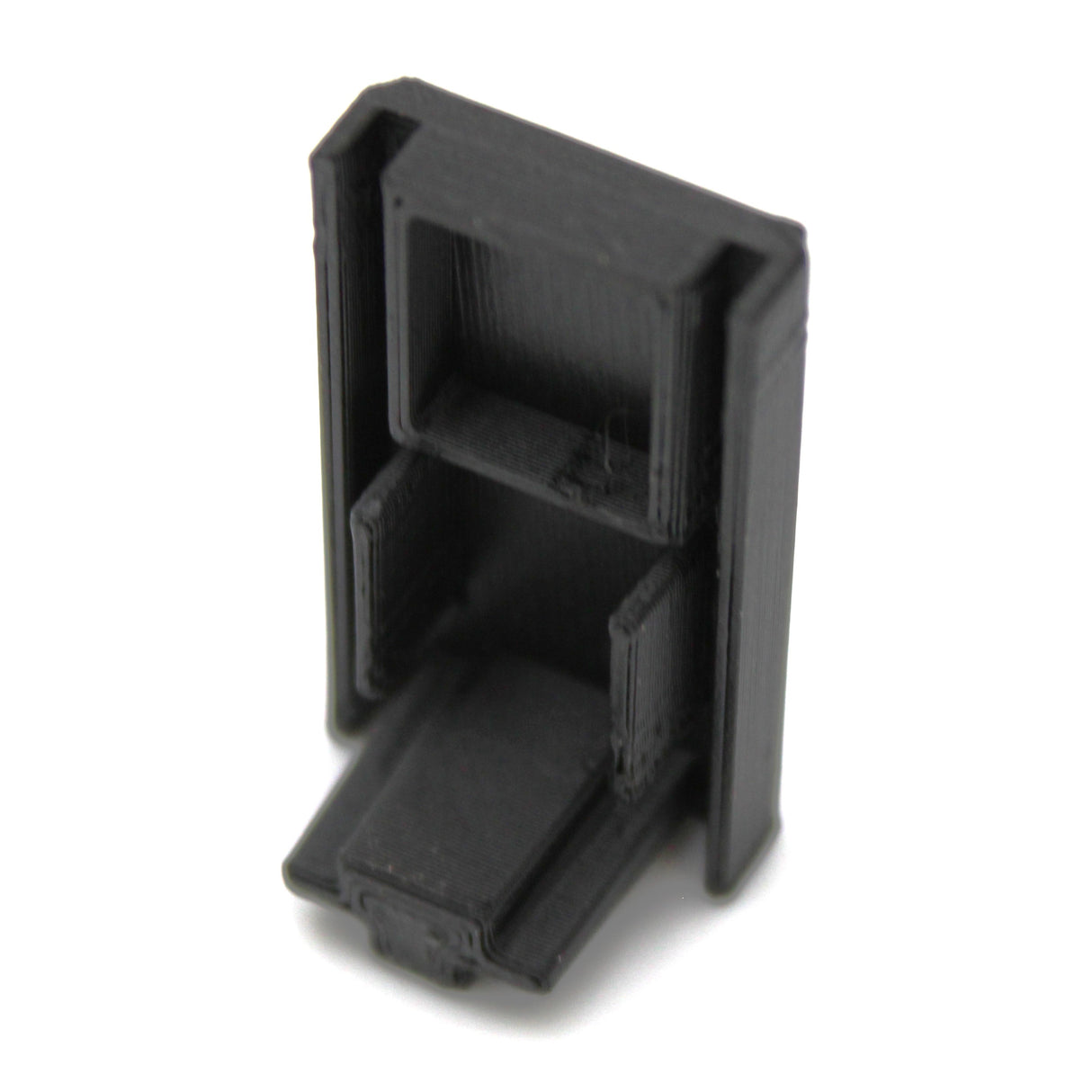 A compact black Plastic End Cap for Hannover Profile, 3D-printed from PETG with rectangular sections and an angled base, shown from above at a slight angle—perfect for finishing your Hannover Profile.