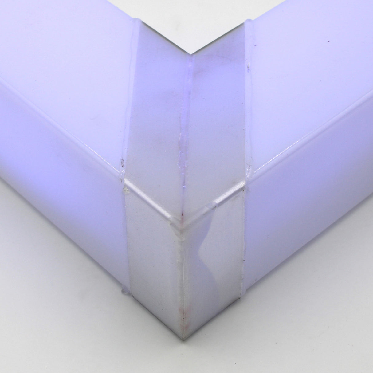 Close-up of the Translucent Elbow for Holston74 Profile, crafted from purple-tinted acrylic at a right angle with smooth surfaces and visible seams, seamlessly bonded using methacrylate adhesive.