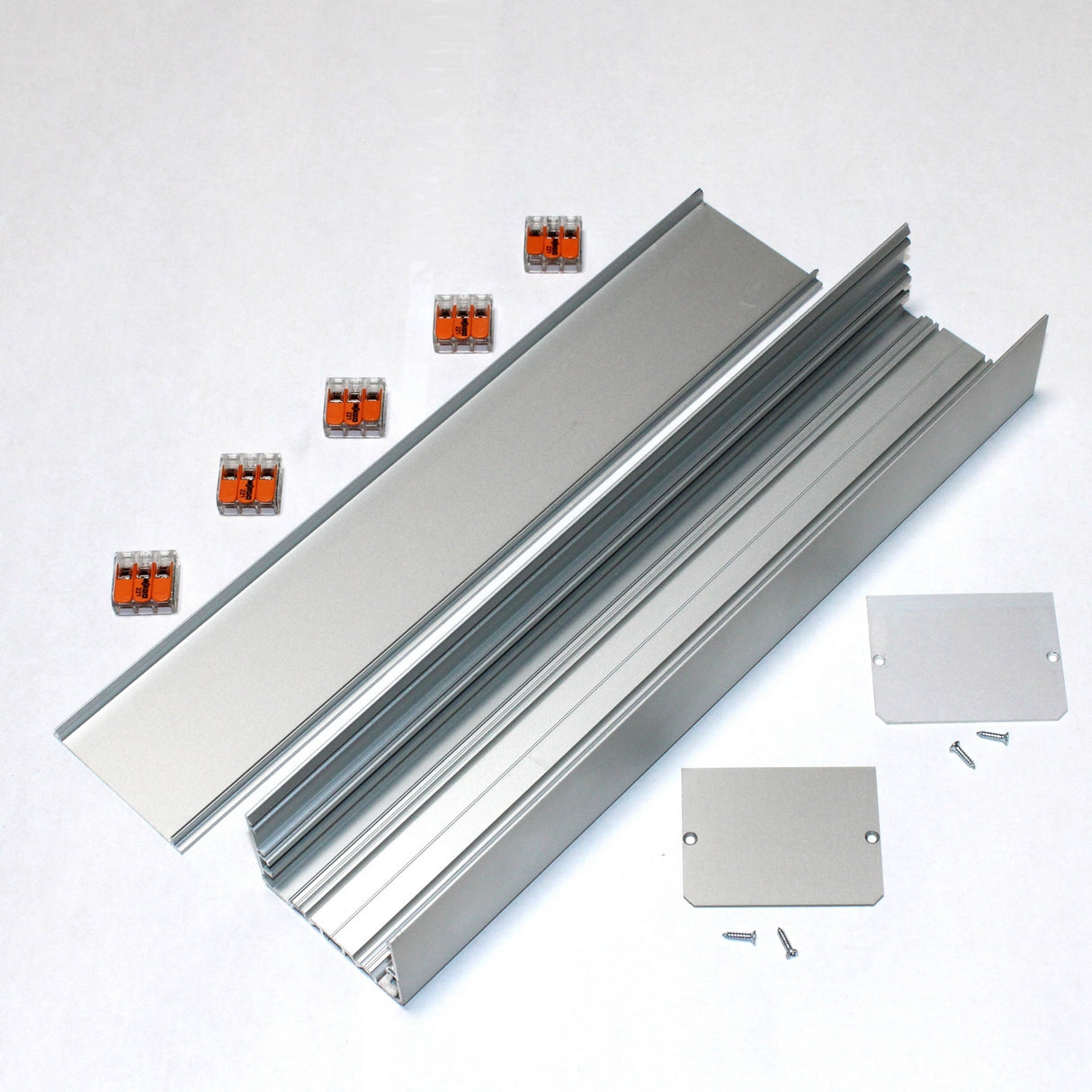 The Custom PL55 J-Box includes aluminum extrusions, two end plates, screws, and six orange wire connectors—ideal for secure electrical connections in LED profiles or linear installations. Components suit enclosure or mounting needs.