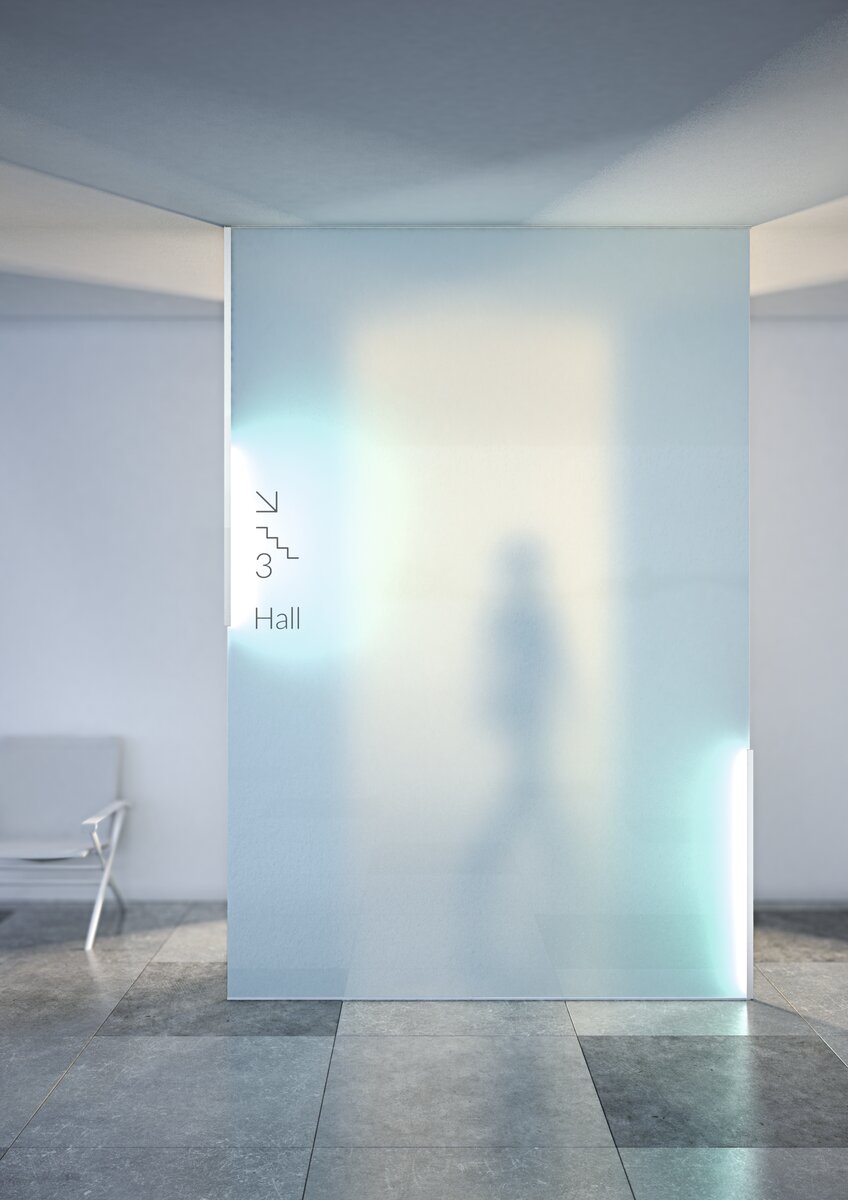 A frosted 1/2 glass wall edge-lit with the Klus KRAV-05IN LED extrusion shows a blurred silhouette behind it; floor tiles and a white chair sit left, while signage directs to stairs for the third-floor hall.