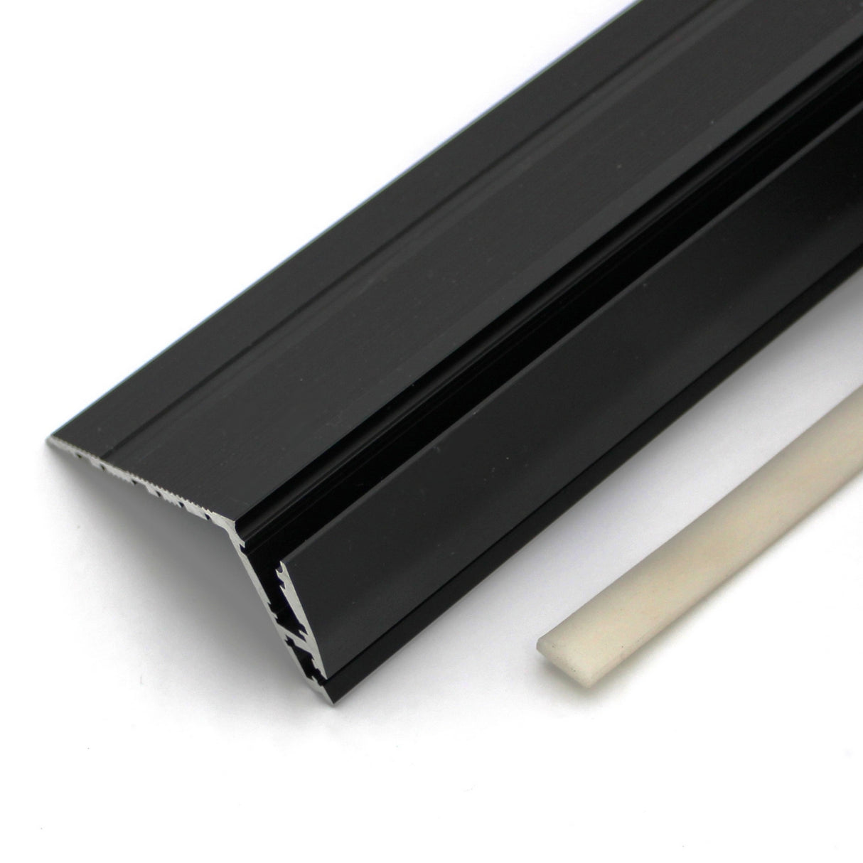 A close-up of the black metal Upper cover for Niza Duo with a triangular profile, shown beside its UV stable white LED diffuser cover, both displayed on a white background.