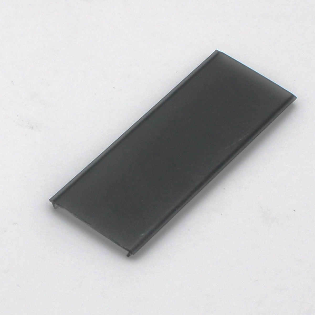 An LED Diffuser for Easy-On Slim/Mini Architectural Profiles, rectangular and thin, made of black plastic or metal, rests on a plain white surface.