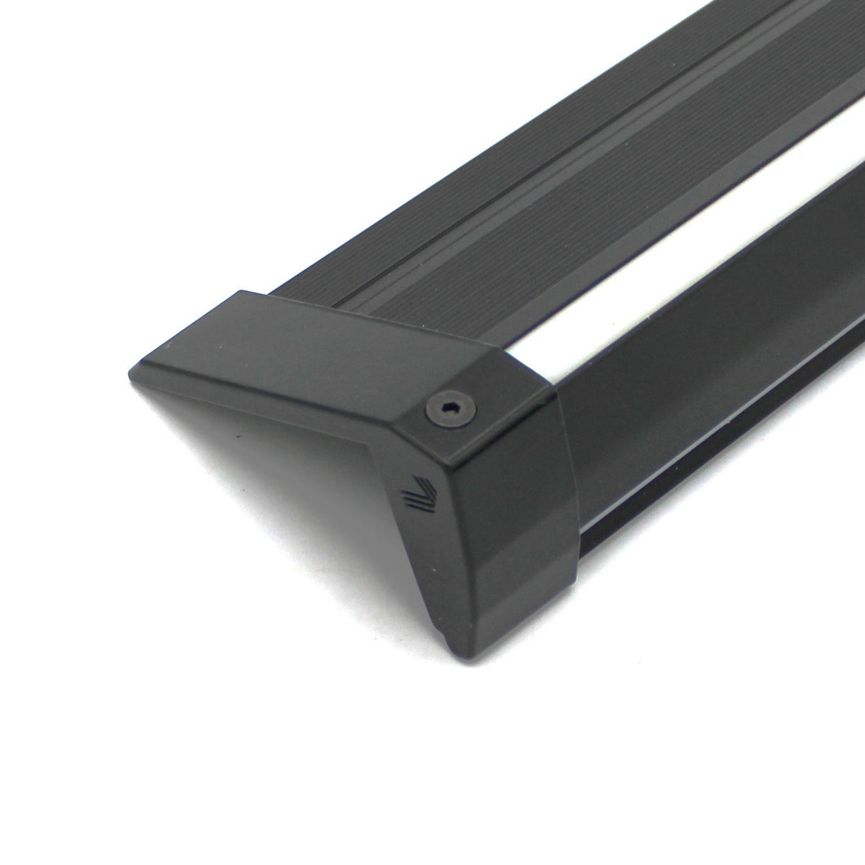 Close-up of the End Cap for Niza Duo, a black, angular cast aluminum edge protector with a ridged texture and screw hole, shown on a white surface.