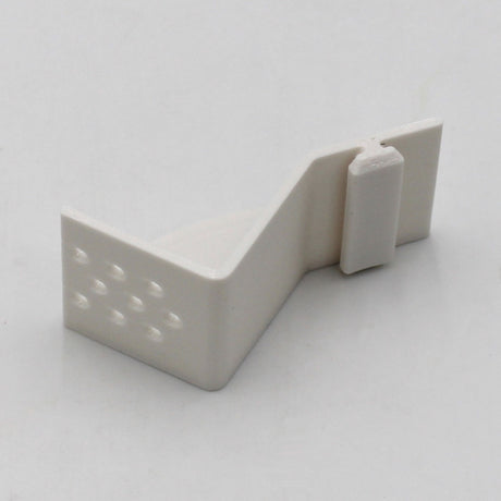 The Plastic Mounting Bracket for Caracas Profile is a small, white, Z-shaped 3D printed bracket with a peg and textured dots on one side, shown against a plain white background. Available from Wired4signs USA.