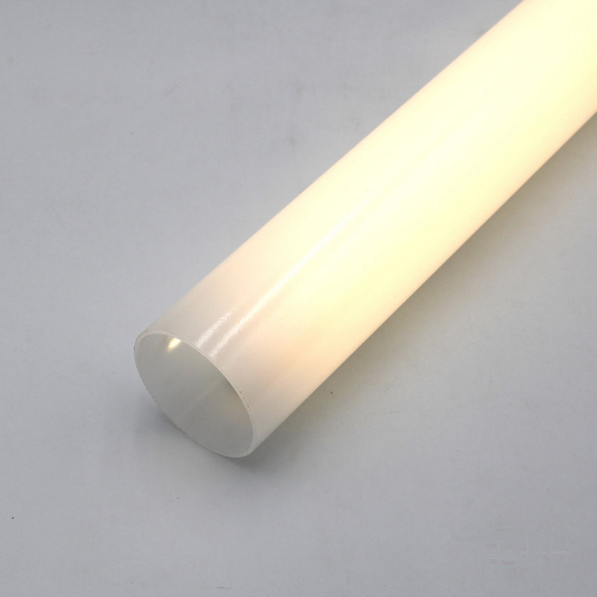 The Diffuser for 360 Degree suspended LED Channel - ALU360 is a white, cylindrical translucent tube shown against a light gray background, illuminated from within to create a soft, glowing effect.