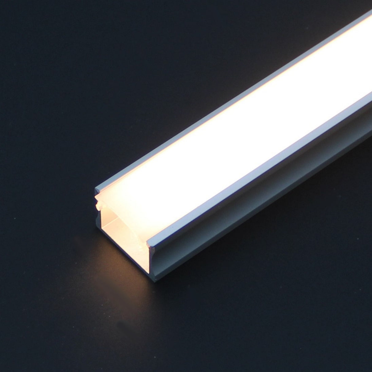 A close-up of the Diffuser for SLW8, RSLW8, SLW15, RO38, Wall LED Lamp series profiles with a glowing rectangular LED and frosted finish, accented by an aluminum frame against a dark background.