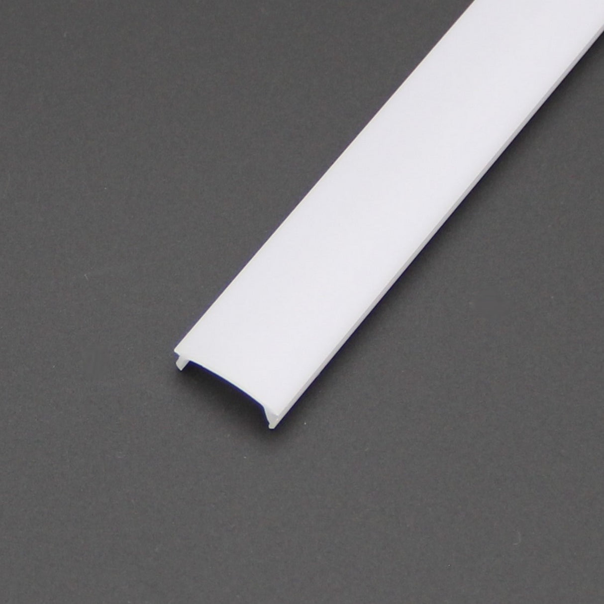 A white, rectangular plastic diffuser for SLW8, RSLW8, SLW15, RO38, and Wall LED Lamp series profiles with a slightly curved surface lies on a dark gray background. Compatible profiles ensure easy and secure installation.