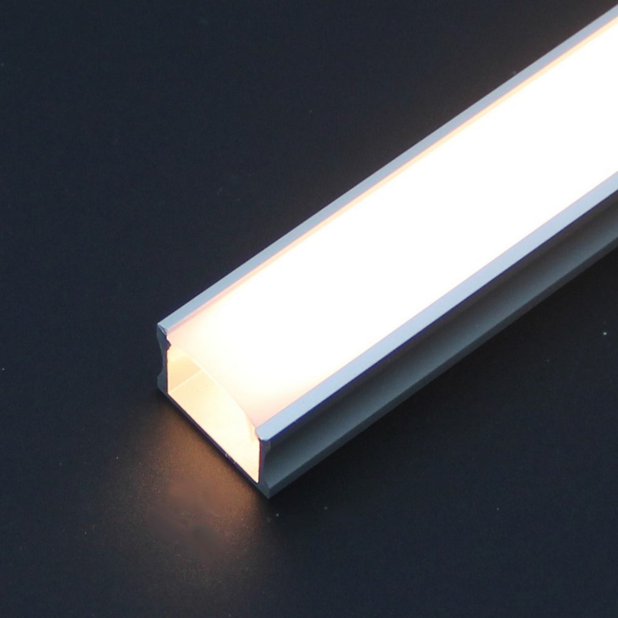 A Diffuser for SLW8, RSLW8, SLW15, RO38, Wall LED Lamp series profiles rests illuminated on a dark surface.