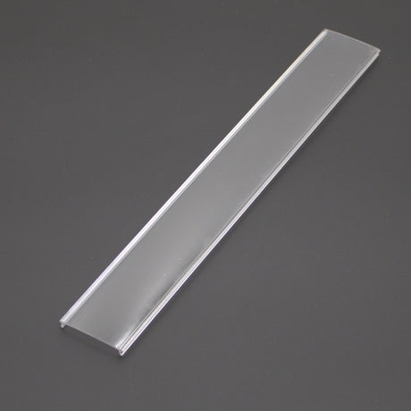 A clear, rectangular diffuser for SLW10, ALU45-Wide profile with beveled edges is set against a dark background, highlighting its sleek design.