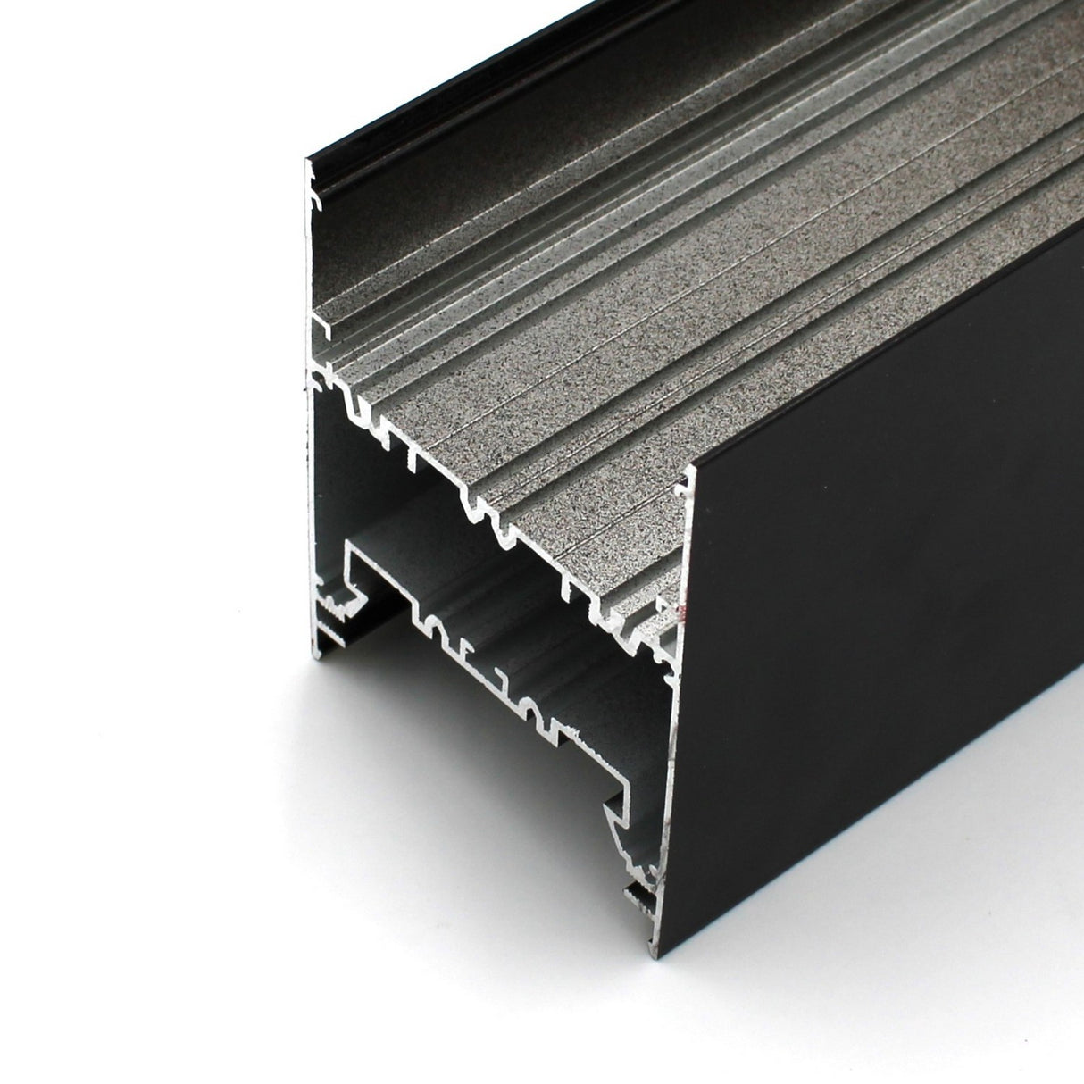 Close-up view of the Direct/Indirect Linear Pendant Lighting LED Channel ~ Model DPL70FL, a black aluminum extrusion with inner channels and grooves, ideal for construction or framing and offering superior heat dissipation.