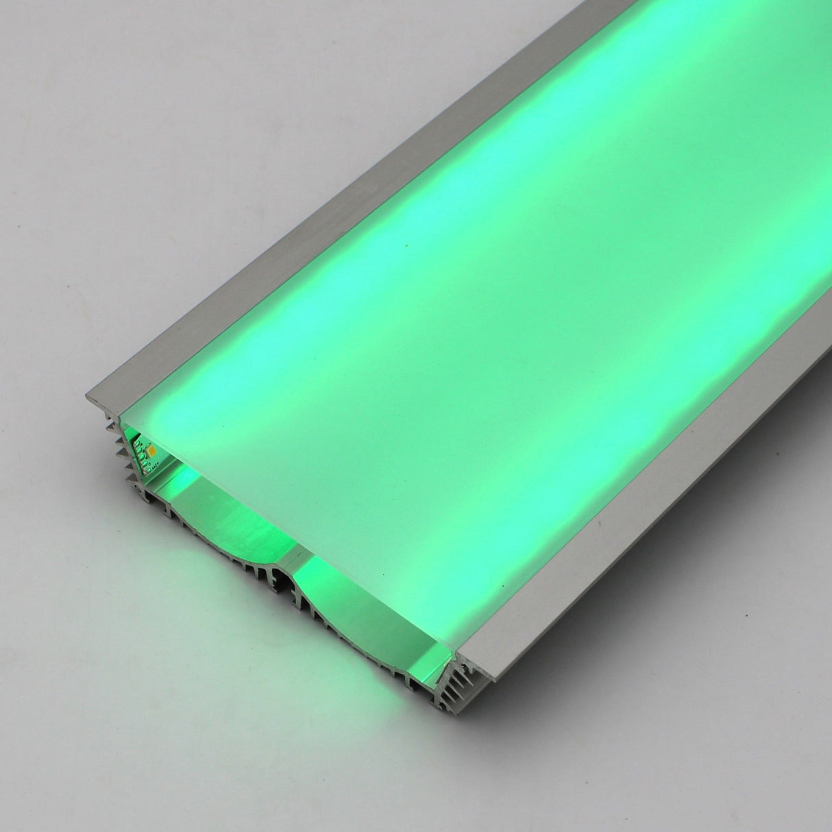 The 4.5 Large Recessed LED Channel (Model RPLW116) features a silver metal frame and emits a bright green glow with extra-wide light output, displayed on a neutral gray surface.