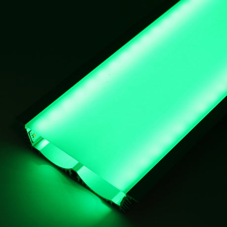 A close-up of the 4.5 Large Recessed LED Channel (Model RPLW116) glows with bright green light against a dark background, its rectangular edges and surface clearly illuminated to showcase the extra-wide light output.