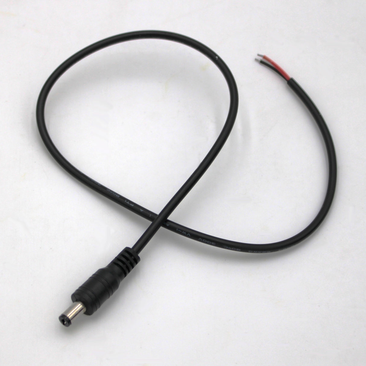 The DC Male 20inch Jack wire features a black 2.1mm DC barrel plug on one end and red/black exposed wires on the other, perfect for surveillance camera connections, shown here on a white surface.