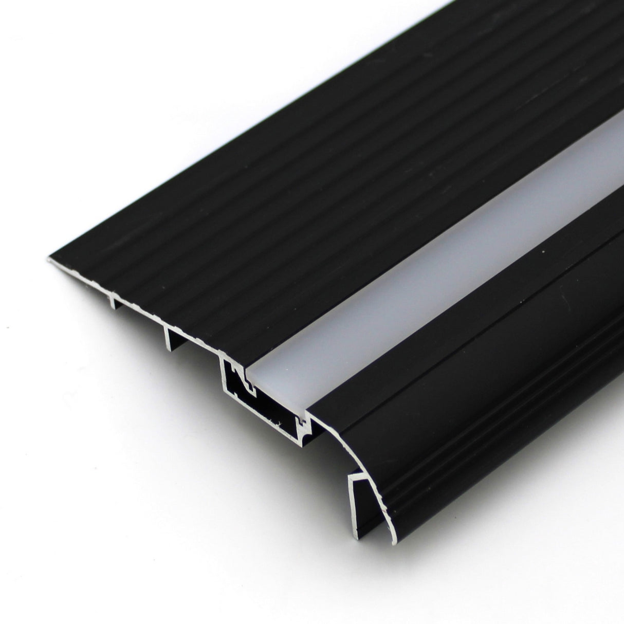 A close-up of the LED Diffuser for Treadable Easy-On Profiles, featuring a ribbed black aluminum base and central gray strip, designed for doorways to cover gaps, ensure smooth floor transitions, and provide durable walk-over safety.