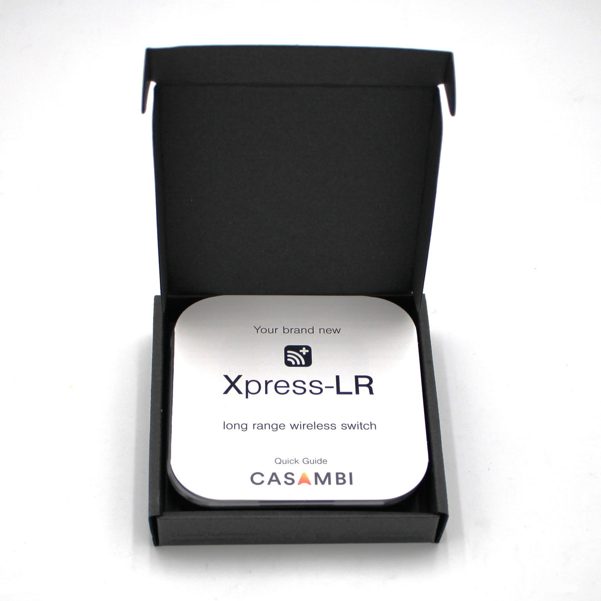 A black box opens to reveal a Casambi basicDIM Bluetooth LED Wall Remote Control ~ Model Xpress-LR Quick Guide, featuring simple icons and text for easy Casambi Bluetooth lighting control setup.