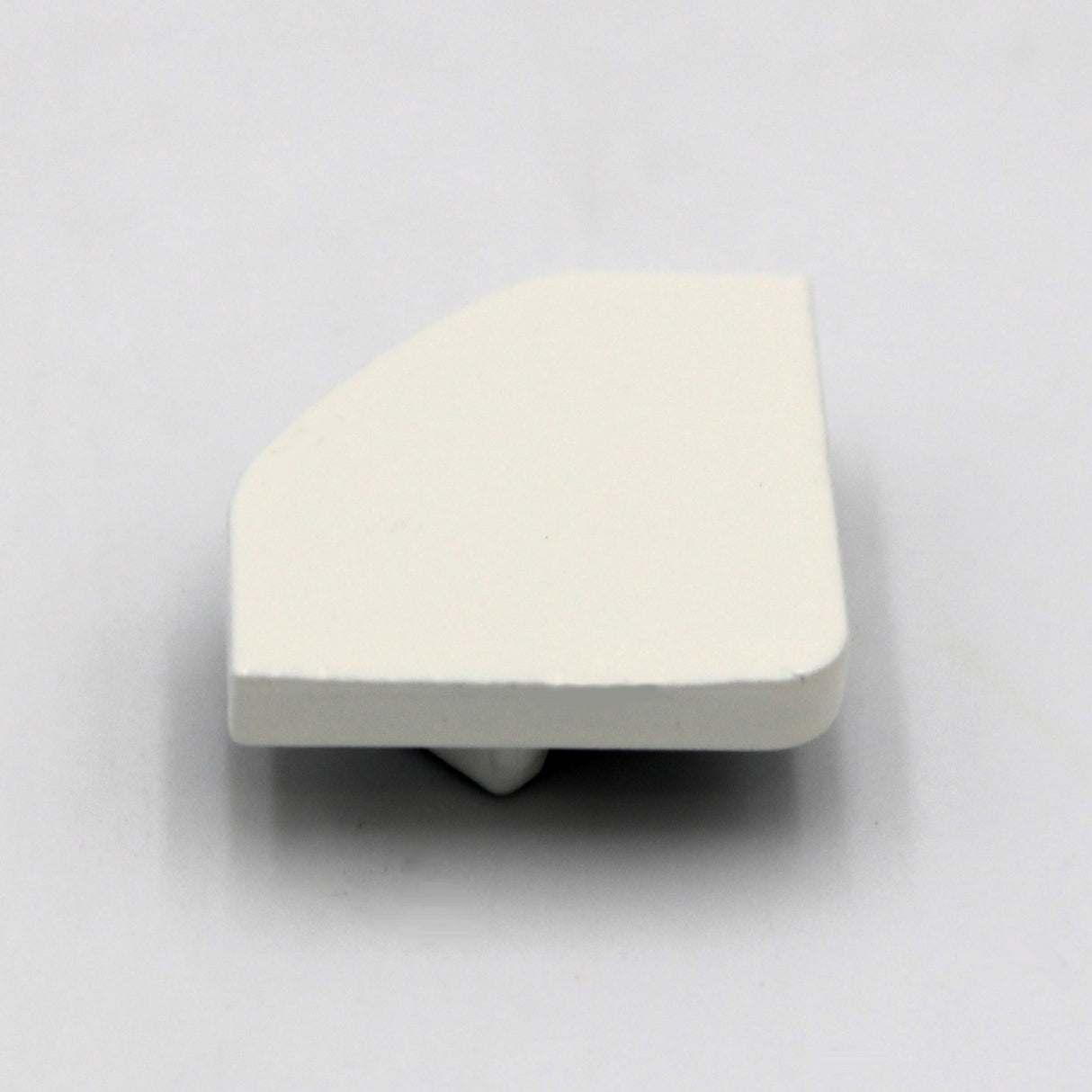 A small, flat, white plastic Single End Cap for LED Channel ~ Alu-45, featuring a slightly angled edge and protruding tab underneath, designed to fit Alu-45 profile lighting fixtures. Shown on a plain white background.