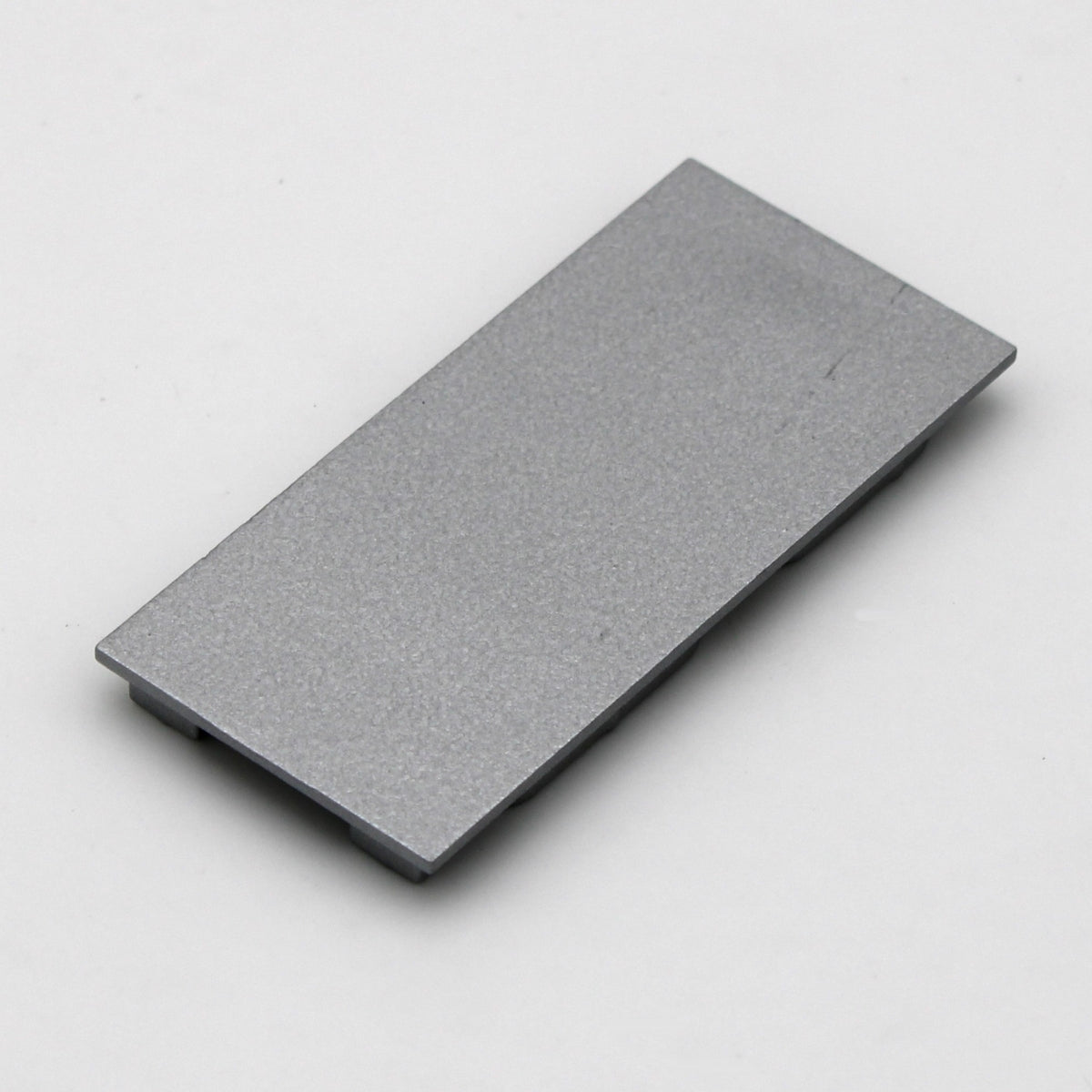 A single Aluminum end cap for PLS33 without cable hole, rectangular and gray with a smooth surface, displayed on a plain white background.