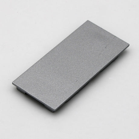 A single Aluminum end cap for PLS33 without cable hole, rectangular and gray with a smooth surface, displayed on a plain white background.