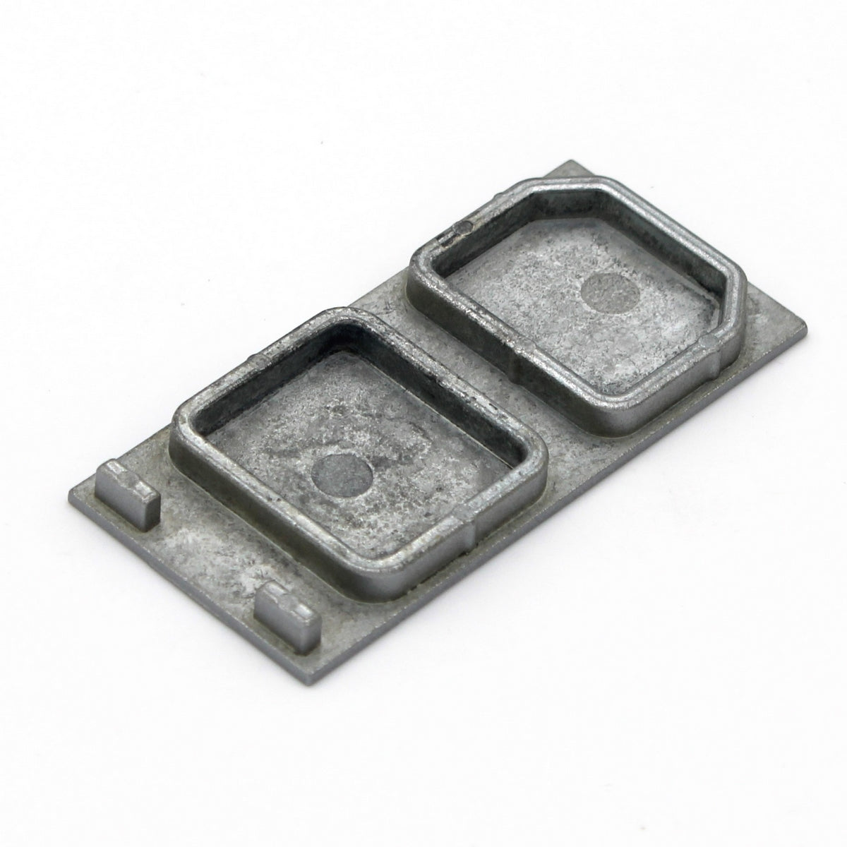 A small, rectangular aluminum end cap for PLS33 without cable hole, featuring two raised compartments on a flat base, is displayed against a plain white background.