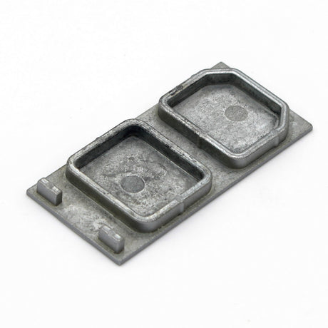 A small, rectangular aluminum end cap for PLS33 without cable hole, featuring two raised compartments on a flat base, is displayed against a plain white background.
