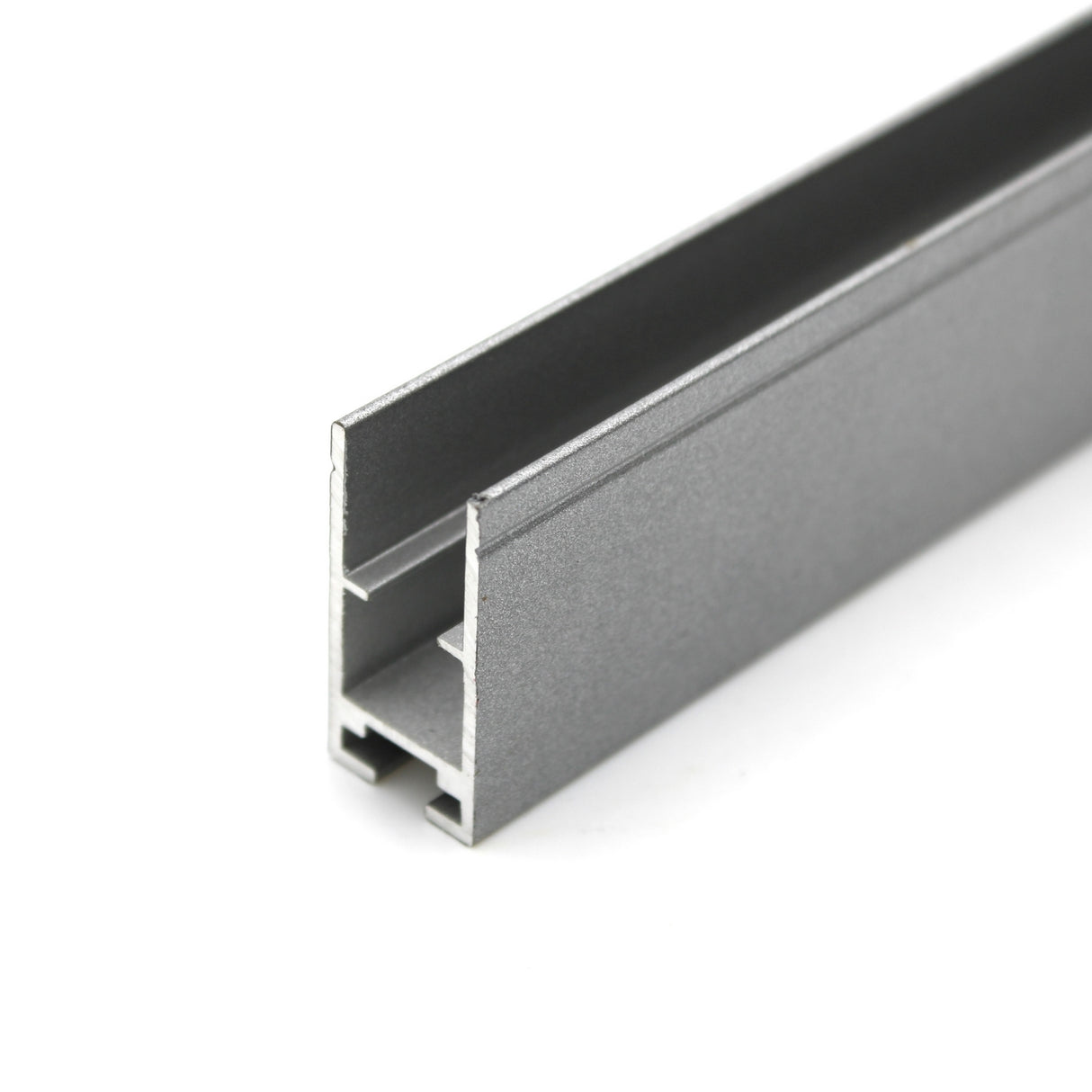 Close-up of the Edge-lit Acrylic Sign Base Channel ~ Model Hannover: a gray, rectangular aluminum profile with a lengthwise channel, ideal for mounting LED strips or supporting edge-lit acrylic signs in framing or construction projects.