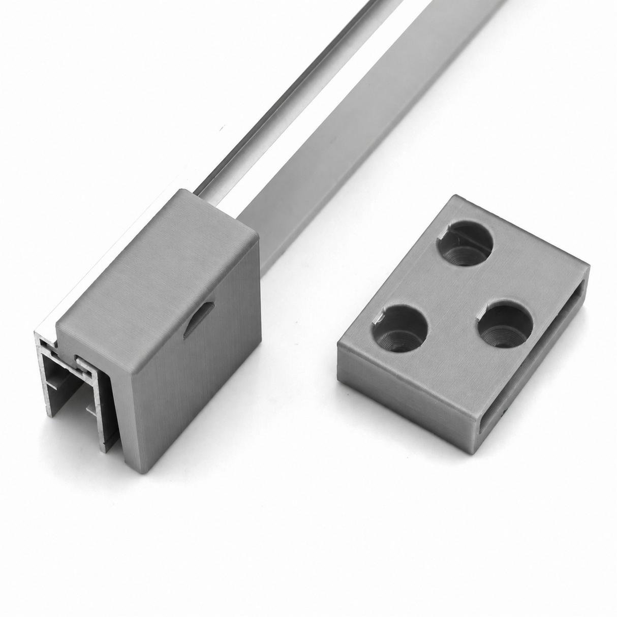 Wall Mounting Bracket for Hannover Profile and a separate flat metal plate with three holes, both displayed on a white background. The main bracket features an open slot, resembling the design of a typical Hannover profile mounting solution and is likely intended for secure structural or mounting applications.
